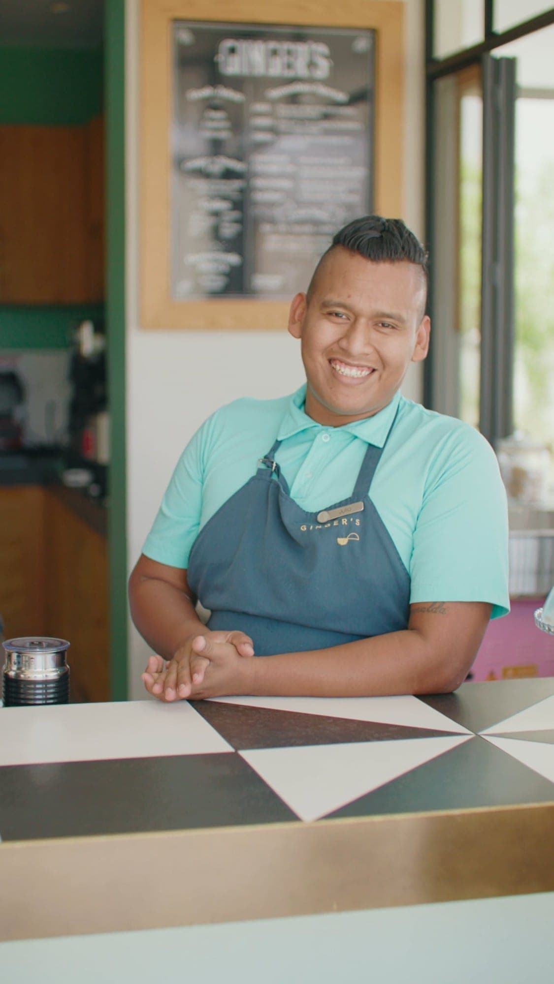 A smiling staff member at Ginger's